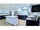 Beautiful kitchen boasts stainless steel appliances, stylish countertops, and a center island with bar stools, perfect for gatherings at 1413 Lithia Pinecrest Rd, Brandon, FL 33511
