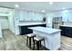 Bright kitchen featuring white cabinets, black countertops, stainless steel appliances, and a center island with bar stool seating at 1413 Lithia Pinecrest Rd, Brandon, FL 33511