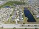 High-angle aerial shot of a community with water features, showcasing the density and layout of homes at 14454 Barley Field Dr, Wimauma, FL 33598