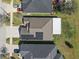 Straight down aerial view highlighting the solar panels and the screened in porch of the house at 14454 Barley Field Dr, Wimauma, FL 33598