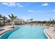 Relaxing community pool featuring a covered lounge area, comfortable seating, and verdant surroundings at 15120 Cuzcorro Ct, Nokomis, FL 34275