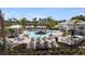 Inviting community pool area featuring modern lounge chairs, cabana, and well-maintained landscaping at 15120 Cuzcorro Ct, Nokomis, FL 34275