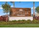 Attractive community sign for Vinterra Townhomes amidst lush landscaping and sunny skies at 15120 Cuzcorro Ct, Nokomis, FL 34275