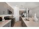 A modern kitchen with gray cabinets, stainless steel appliances, and a spacious island at 15120 Cuzcorro Ct, Nokomis, FL 34275