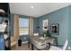 Stylish home office with modern desk, decor, and a large window offering natural light at 15120 Cuzcorro Ct, Nokomis, FL 34275