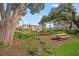 Community picnic area with wooden tables and lush greenery, perfect for outdoor dining and relaxation at 15120 Cuzcorro Ct, Nokomis, FL 34275