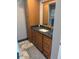 Bathroom featuring wood cabinets, granite countertops, and tile flooring at 1520 Gulf Blvd # Ph2, Clearwater Beach, FL 33767