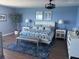 Stylish bedroom with a king bed, patterned blue bedding, and bedside lamps at 1520 Gulf Blvd # Ph2, Clearwater Beach, FL 33767