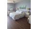 Comfortable bedroom with hardwood floors and floral accents at 1520 Gulf Blvd # Ph2, Clearwater Beach, FL 33767