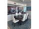 Elegant dining area adjacent to a modern kitchen, featuring a view, and a stylish table setting at 1520 Gulf Blvd # Ph2, Clearwater Beach, FL 33767
