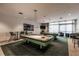 Bright game room featuring two billiard tables, modern lighting, and comfortable seating at 1520 Gulf Blvd # Ph2, Clearwater Beach, FL 33767