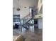 Open-concept living room with large staircase and floor-to-ceiling windows showcasing ocean views at 1520 Gulf Blvd # Ph2, Clearwater Beach, FL 33767