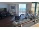 Cozy living room with ocean views, comfortable seating, and a TV entertainment center at 1520 Gulf Blvd # Ph2, Clearwater Beach, FL 33767