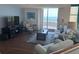 Bright living room with ocean view, comfortable seating, and modern furnishings at 1520 Gulf Blvd # Ph2, Clearwater Beach, FL 33767