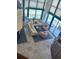 Bright living room featuring a corner view, ample seating, and neutral tile flooring at 1520 Gulf Blvd # Ph2, Clearwater Beach, FL 33767