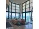 Bright living room with floor-to-ceiling windows offering stunning ocean views and comfortable seating at 1520 Gulf Blvd # Ph2, Clearwater Beach, FL 33767
