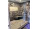 Modern shower with rainfall showerhead, bench, and tile surround at 1520 Gulf Blvd # Ph2, Clearwater Beach, FL 33767