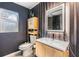 Modern bathroom featuring a sleek vanity, unique mirror, and gray walls with an accent wall at 1905 Dove Field Pl, Brandon, FL 33510