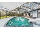 The screened-in pool area has a slide and furniture creating a great atmosphere for relaxation and entertainment at 1905 Dove Field Pl, Brandon, FL 33510