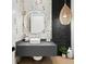 Fun powder room boasting monkey-themed wallpaper, round mirror, dark vanity and decorative hanging light fixture at 1906 Carolina Ne Ave, St Petersburg, FL 33703