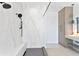 Bathroom featuring glass shower, double shower heads, white marble wall and built-in shelves at 1906 Carolina Ne Ave, St Petersburg, FL 33703