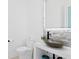Modern bathroom features stone accent wall, updated vanity, and toilet at 1906 Carolina Ne Ave, St Petersburg, FL 33703