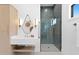 Modern bathroom featuring a walk-in shower with stylish tile and a floating vanity with unique mirror at 1906 Carolina Ne Ave, St Petersburg, FL 33703