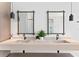 Modern bathroom featuring double sinks, stylish mirrors, sleek fixtures and decorative plant at 1906 Carolina Ne Ave, St Petersburg, FL 33703