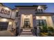 Grand entrance to a modern home with stone accents, manicured landscaping, and elegant lighting at 1906 Carolina Ne Ave, St Petersburg, FL 33703