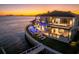 Stunning waterfront estate with infinity pool, multiple balconies, and a beautiful sunset backdrop at 1906 Carolina Ne Ave, St Petersburg, FL 33703