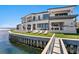 Waterfront home featuring a pool, outdoor kitchen, and multiple lounge areas for entertaining at 1906 Carolina Ne Ave, St Petersburg, FL 33703