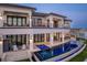 Luxury home exterior featuring a pool, outdoor kitchen, and private dock with serene lighting at 1906 Carolina Ne Ave, St Petersburg, FL 33703