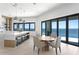 Bright kitchen and dining area with an island and large windows overlooking the water at 1906 Carolina Ne Ave, St Petersburg, FL 33703