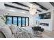 Cozy main bedroom with fireplace, chandelier, and sliding glass doors to ocean view balcony at 1906 Carolina Ne Ave, St Petersburg, FL 33703