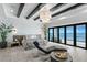 Tranquil main bedroom featuring wood beam ceiling, chandelier, and gorgeous ocean view through sliding glass doors at 1906 Carolina Ne Ave, St Petersburg, FL 33703