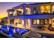 Luxury home exterior featuring a modern pool with in-water loungers and a spacious patio with ample seating at 1906 Carolina Ne Ave, St Petersburg, FL 33703
