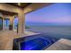 Covered patio with infinity pool featuring a spa, overlooking the bay and private dock at 1906 Carolina Ne Ave, St Petersburg, FL 33703