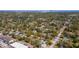 An aerial view of a property in a neighborhood with mature trees and city views in the distance at 1941 48Th S St, St Petersburg, FL 33711