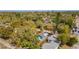 An aerial view of a charming blue house with a lush green backyard, nestled among mature trees at 1941 48Th S St, St Petersburg, FL 33711
