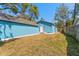 Exterior view of the backyard featuring a blue house and shed at 1941 48Th S St, St Petersburg, FL 33711