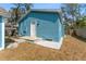 Exterior view of the blue house with white gravel landscaping and backyard at 1941 48Th S St, St Petersburg, FL 33711