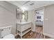 Bathroom view featuring a double sink vanity, decorative mirrors, and a doorway to the bedroom at 1941 48Th S St, St Petersburg, FL 33711
