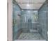 Updated walk-in shower featuring stylish blue tiling and glass door at 1941 48Th S St, St Petersburg, FL 33711