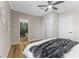Bedroom showcasing wood floors, ceiling fan, closet, and en suite bathroom with glass enclosed shower at 1941 48Th S St, St Petersburg, FL 33711