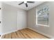 Bedroom featuring wood-look floors, a closet, a ceiling fan, and a window at 1941 48Th S St, St Petersburg, FL 33711