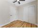 Bright bedroom featuring wood floors, ceiling fan, closet, and white trim throughout at 1941 48Th S St, St Petersburg, FL 33711