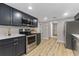 Modern kitchen boasting stainless steel appliances and sleek dark cabinets at 1941 48Th S St, St Petersburg, FL 33711