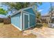 Exterior of the turquoise shed with a single entry door, adjacent to the yard at 1941 48Th S St, St Petersburg, FL 33711
