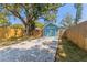 Exterior view of the turquoise shed with an adjacent gravel driveway at 1941 48Th S St, St Petersburg, FL 33711