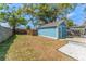 Wide-angle view of the turquoise shed, showing the yard, steps, and AC unit at 1941 48Th S St, St Petersburg, FL 33711